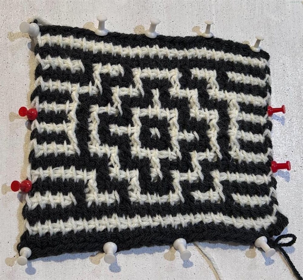 Black and white Tunisian crochet mosaic swatch pinned flat
